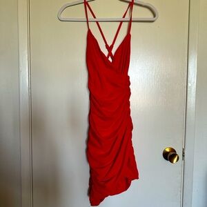 Red asymmetrical mini dress with a ruched side and criss cross straps